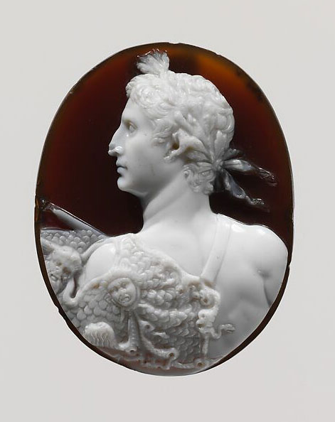 Oval carving featuring a profile of a classical figure in white against a dark background