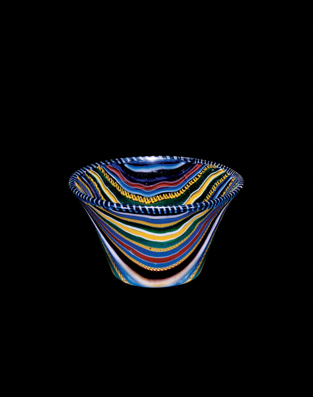 Vibrant, multi-colored glass bowl with swirling patterns of blue, yellow, red, black, and green stripes