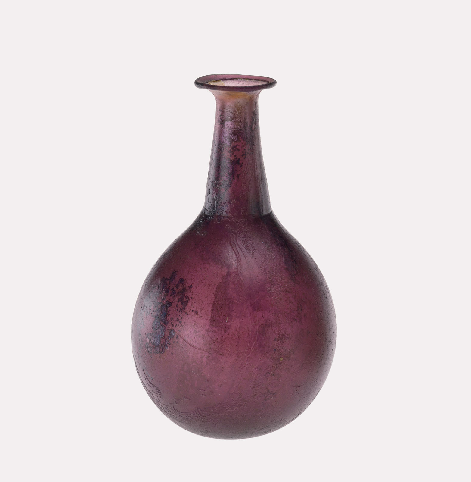 Slender, transparent purple glass bottle with a narrow neck and rounded body, showing signs of age