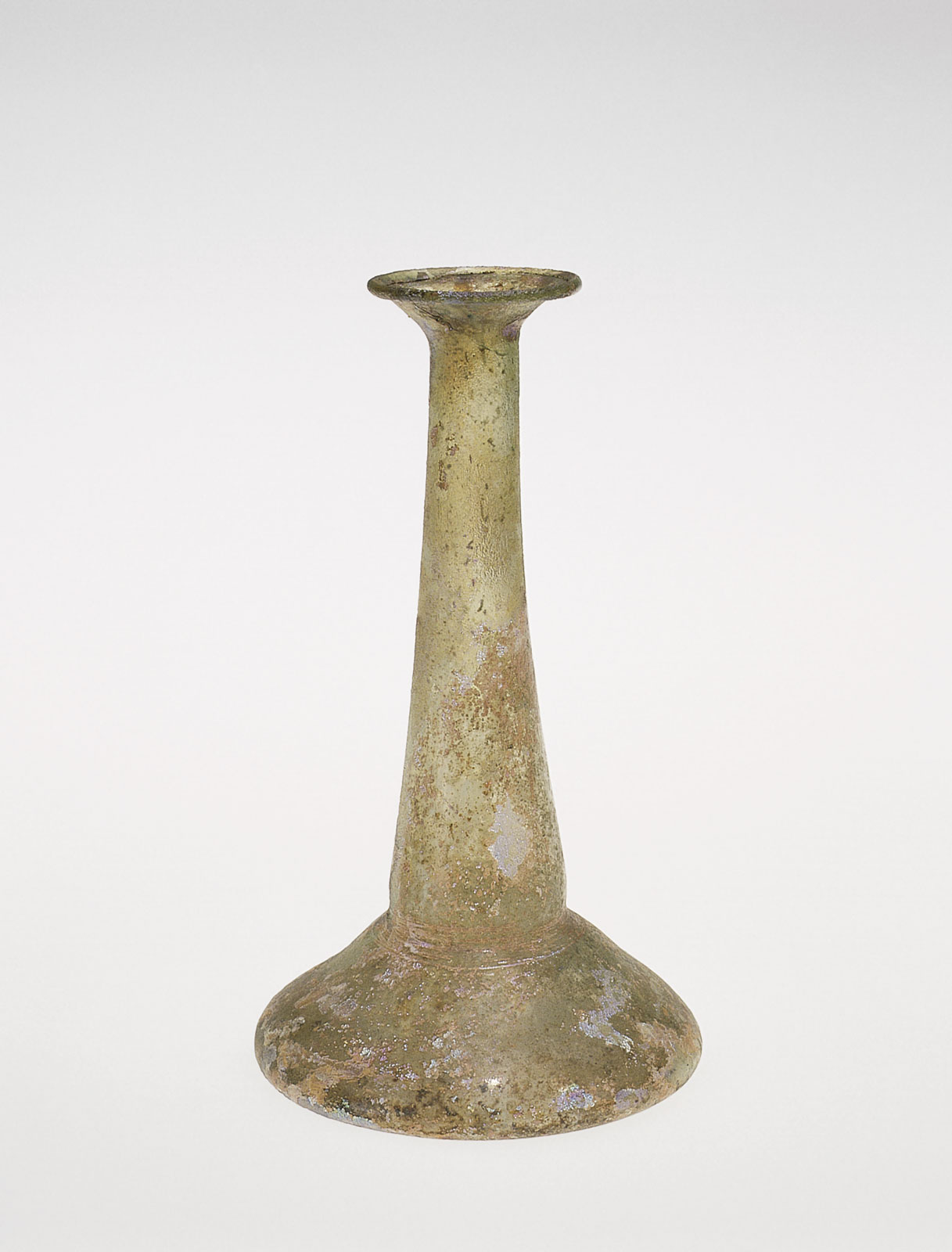 Unadorned glass flask with a broad base and a long, slim neck with age-textured surface