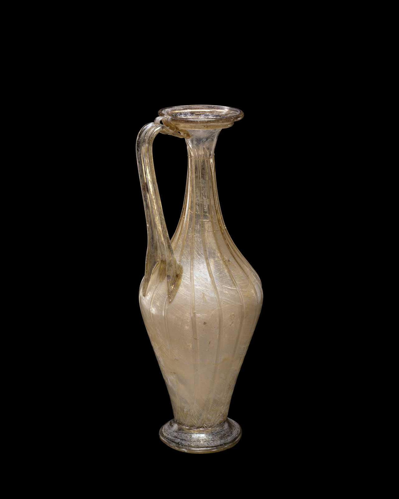 Translucent glass vase with an elegantly curved handle, a tapered neck, and detailed with fine vertical grooves