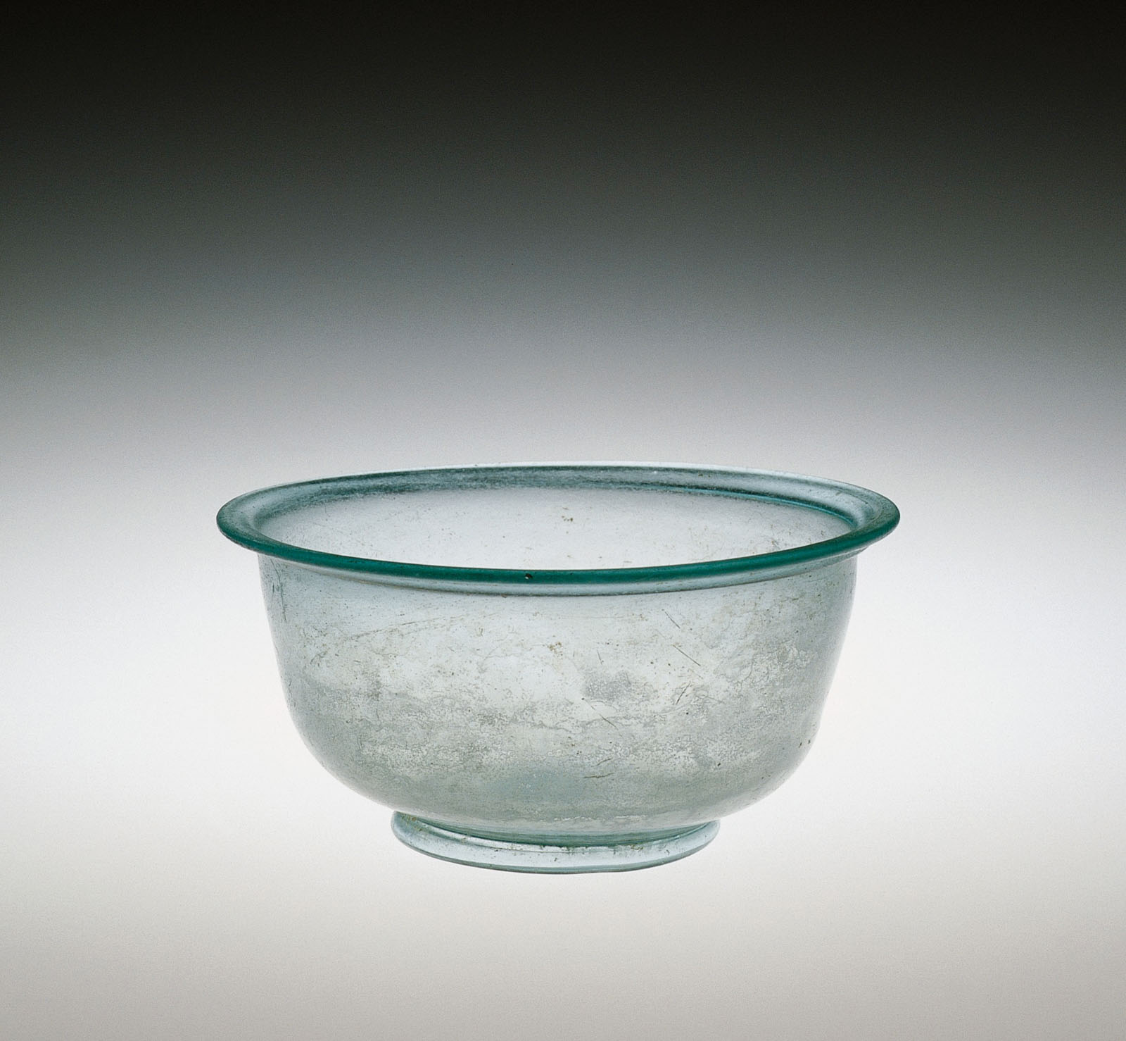 Transparent, unadorned pale blue-green  glass bowl