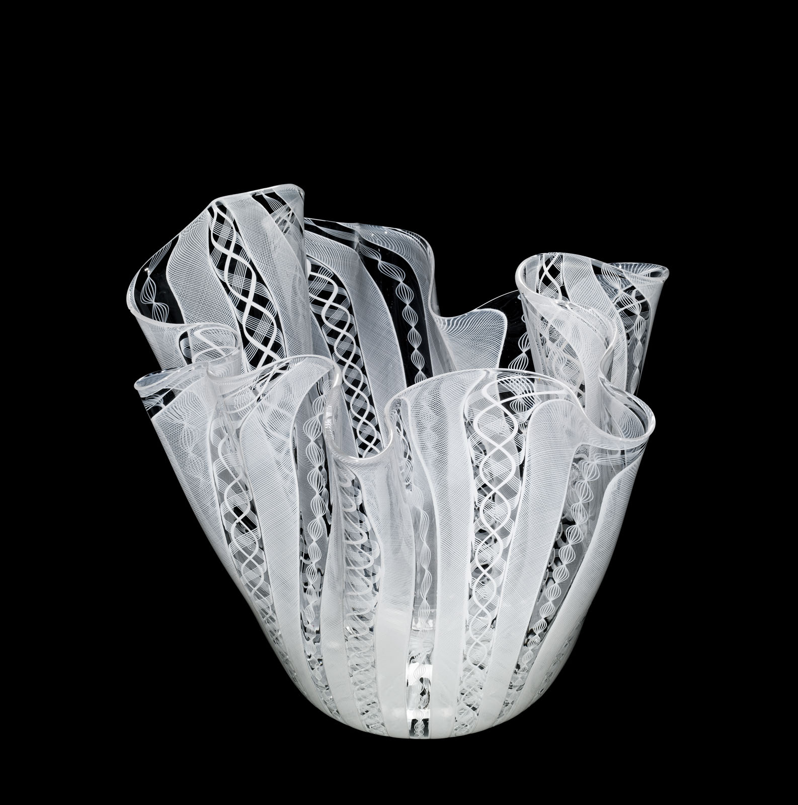 White and clear glass vase with undulating shape and intricate spiral latticework patterns